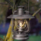 Feuerhand LED Laterne Baby Special 276 hung on a tree, showcasing its traditional design and modern LED technology.