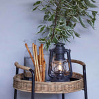 Feuerhand LED Laterne Baby Special 276 auf einem Tisch mit Snacks und Wasser, im stimmungsvollem Licht.