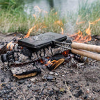 Waffeleisen von Petromax über offenem Feuer, ideal für knusprige Waffeln im Freien.