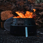 Atago Black Edition outdoor cooking setup with flames and grill ready for use.